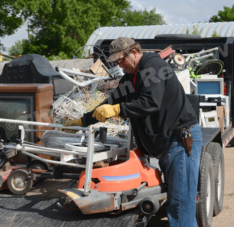 Jerry Finkrel loads up metal junk to a trailer to be hauled away. E-R photo