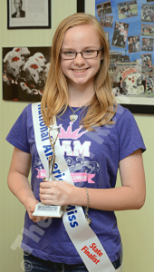 Breanna Carr is pictured with her sash, t-shirt, bracelet and necklace that she wore throughout most of the weekend. She was a state finalist at May’s 2015 Miss Nebraska Junior Teen Pageant in Omaha. E- R photo