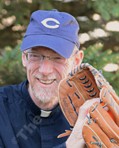 Fr. Ross Burkhalter will wear #3 tomorrow in the I-80 Collar Series softball game. E-R photo