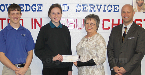 Scott Moser and Terri Seier present the check to Nita Totten and Jake Claussen. Photo submitted