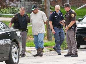 Antelope County Sheriff Bob Moore leads Stacy Colman to a Nebraska State Patrol car following his arrest on Wednesday for violations of the Sex Offender Registry Act. Sheriff Moore and Deputy Timothy Schultz (far right) were assisted by the two members of the Nebraska State Patrol. Elgin Review photo