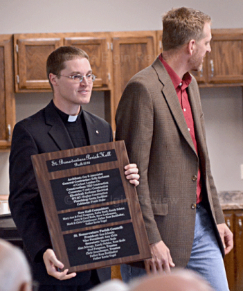 Kelly Kerkman (r) represented the workers on the project and presented a plaque to the parish.